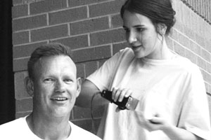 Coach Bob Backus gets his head shaved during the Sept. 16 FCA Kickoff.