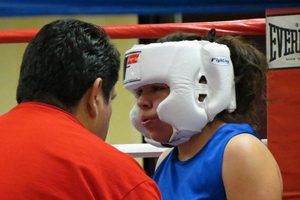 Lexi Saiz and her coach in the corner of the ring before a match.