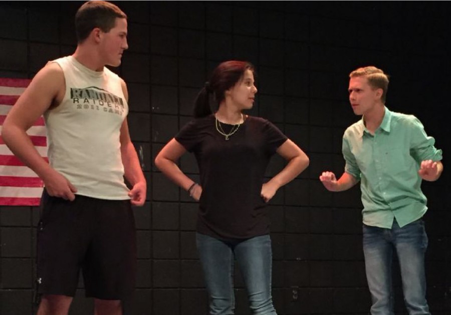 Cutter Pairs, Madee Licky, and Weston Peirce rehears a scene on stage.