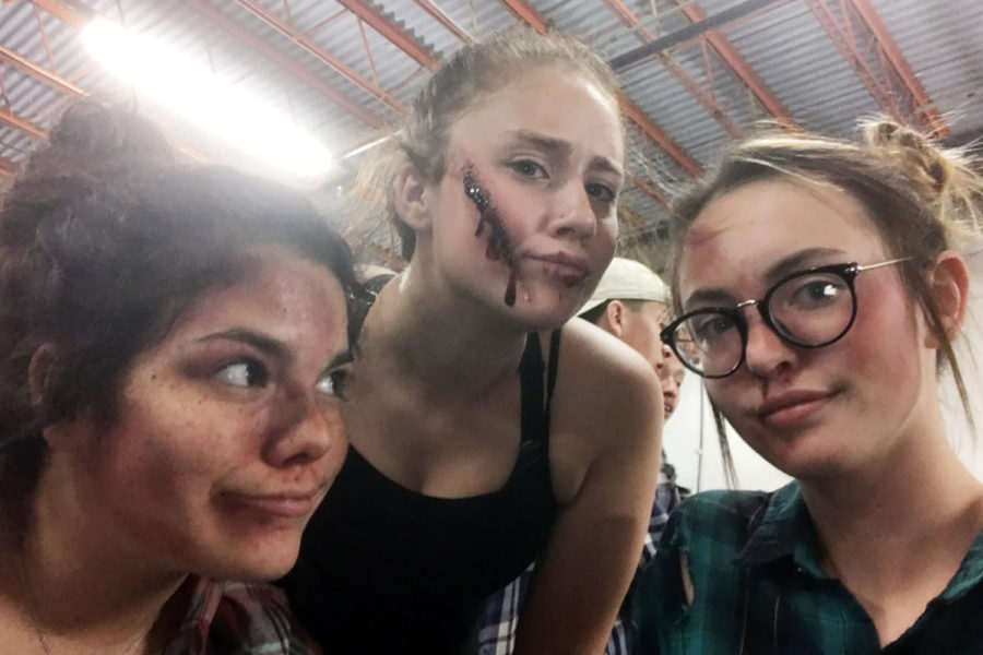 Madison Owensby, Cady Munselle, Cailey Dinga get ready to work the haunted house.