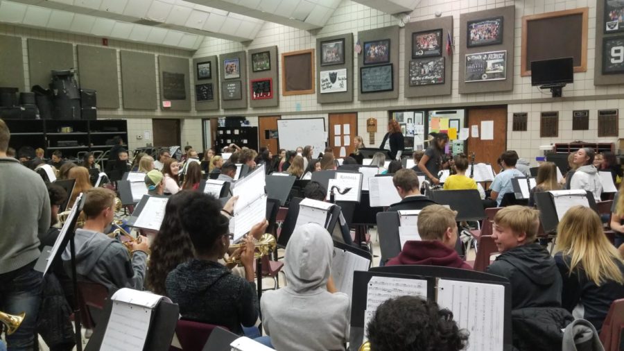 The band practices playing music during their first period band class.