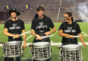 Drumline members play in front of the student section during a home game at Kimbrough Stadium. 