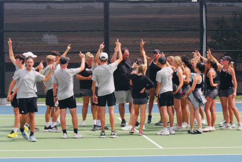 The varsity tennis team celebrates after a district win. The team will begin playoffs Oct. 14. 