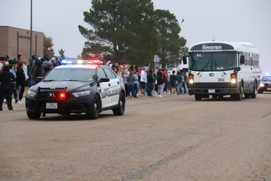 Students gather outside in frigid temperatures to send off the girls' cross country team to state. 