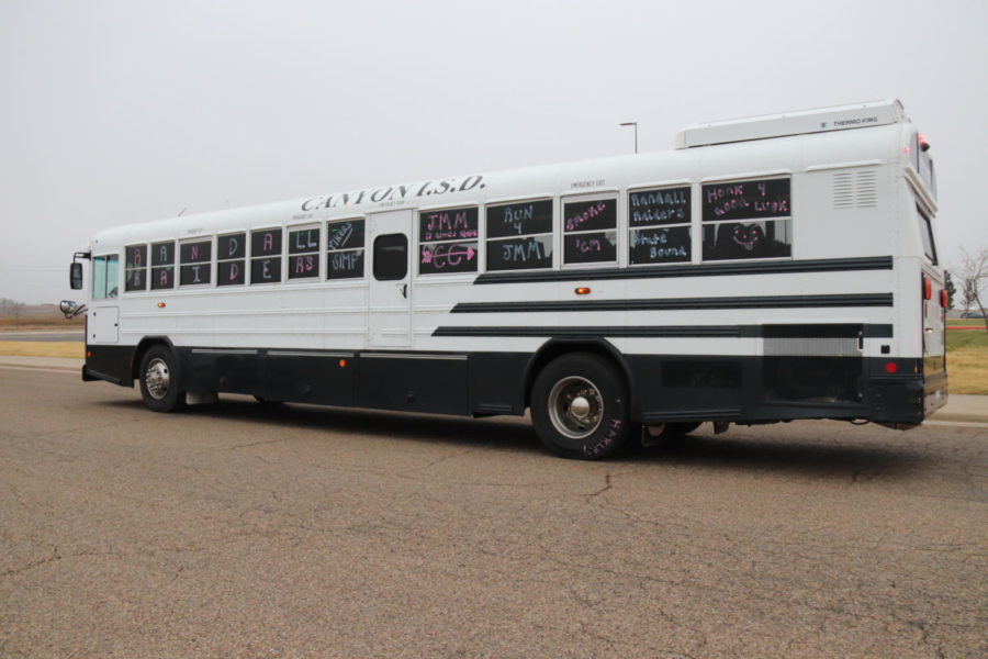 The CISD bus carrying the Randall girls cross country team departs the school on Nov. 7 bound for the state meet. 