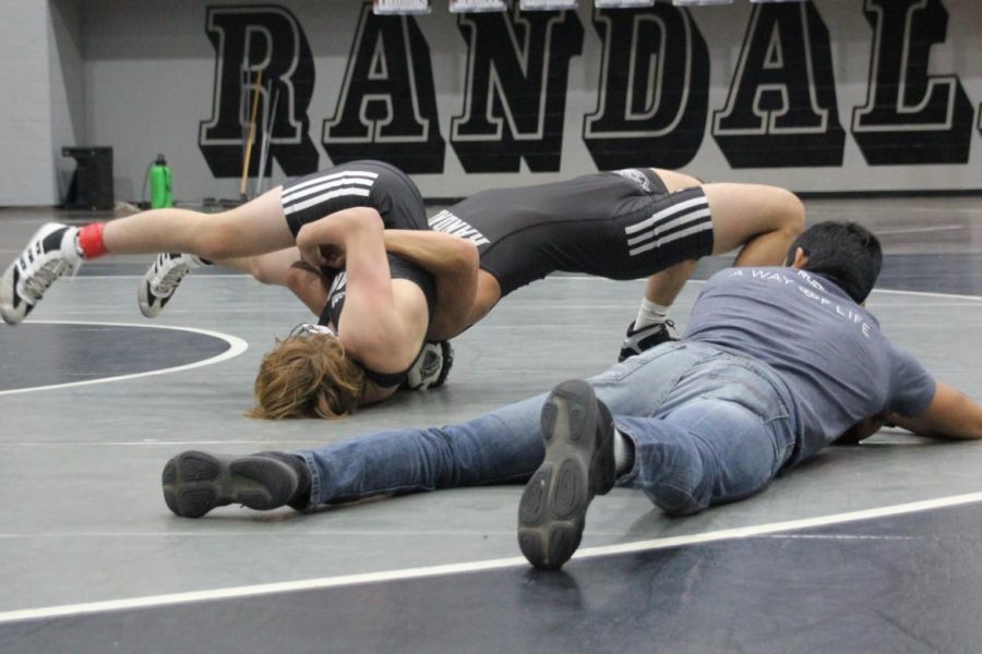 Coach David Quirino officiates while Randall wrestlers compete for a spot on varsity. 