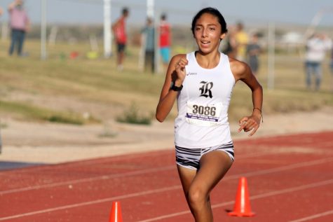 Lizzy Chen crosses the finish line during the Oct. 2 meet at Canyon High School. 