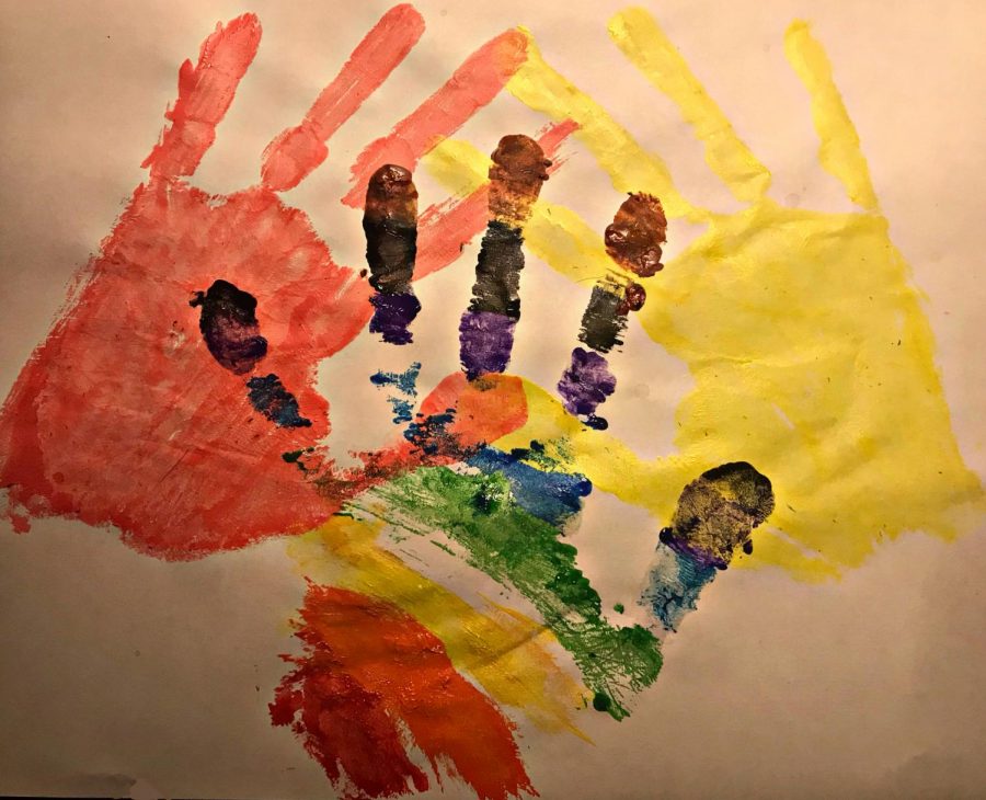 To represent the cultures that are talked about in this series, senior, Mariam Alashmawi painted hand-prints. Pink representing Southeast Asian people, the rainbow representing LGBTQ+ people, and yellow representing disabled people.