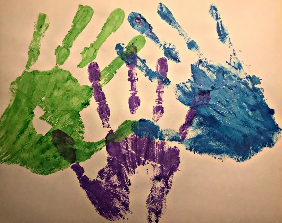 To represent the cultures that are talked about in this series, senior, Mariam Alashmawi painted hand-prints. Green representing Asian people, purple representing Middle Eastern people, and blue representing the Pacific Islander people.