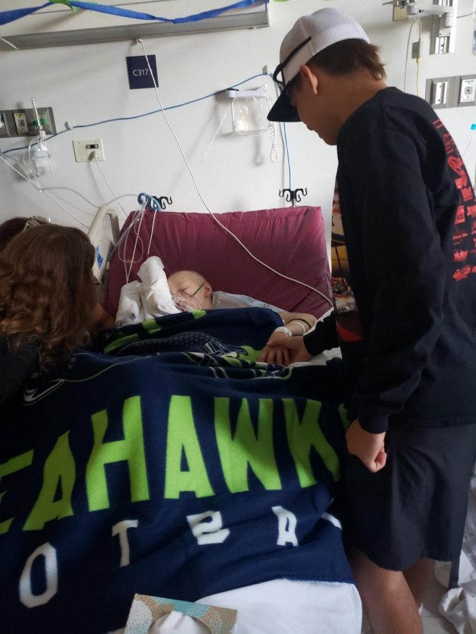 Trae Ferril holds Taydens hand in the hospital. 