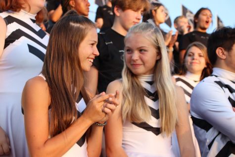 Color Guard members Hailey Roberson and Alexiah Ferril enjoy the Friday night game.