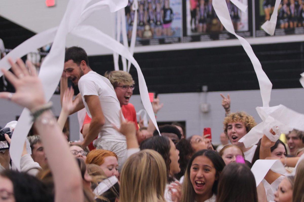 Seniors chant V-I-C-T-O-R-Y while toilet paper is thrown at the white-out pep rally on Sept. 28. 
