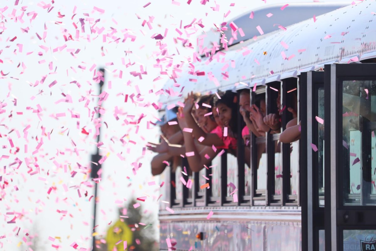 The girls soccer team waves to students and parents who threw confetti as they leave for the state championship game in Georgetown, Texas, on April 8. The team won against Wimberly 3-2. 