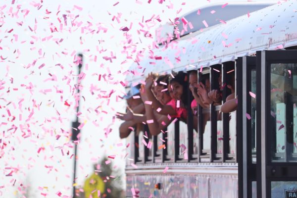 The girls soccer team waves to students and parents who threw confetti as they leave for the state championship game in Georgetown, Texas, on April 8. The team won against Wimberly 3-2. 